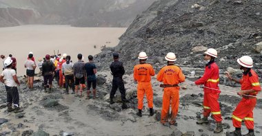 A handout photo made available by the Myanmar Fire Services Department shows rescue workers searching for people after a landslide accident at a jade mining site in Hpakant, Kachin State, Myanmar, July 2, 2020. (Myanmar Fire Services via EPA)