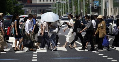 People walk on a pedestrian crossing in Tokyo, July 2, 2020. (AP Photo)