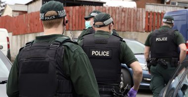 The picture shows police during a raid in Operation Venetic, an investigation on Encrochat, a military-grade encrypted communication system used by organised criminals trading in drugs and guns, July 2, 2020. (AP)