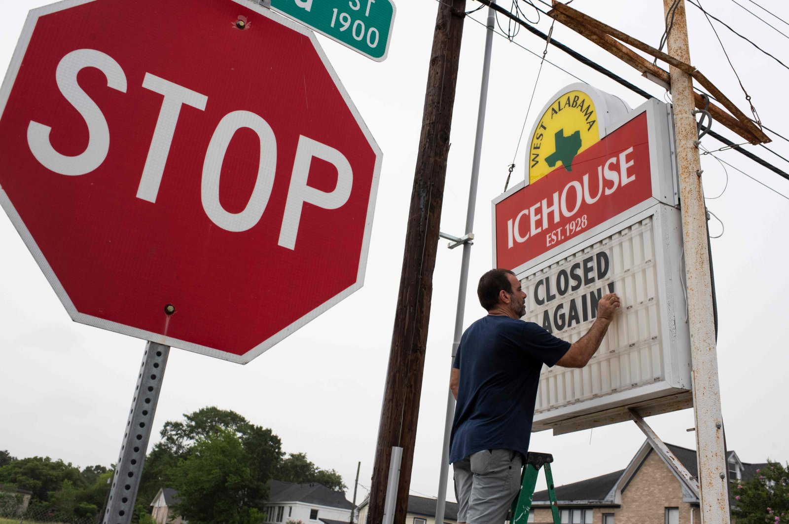 Bar owner Petros J Markantonis changes the marquee outside his bar to "Closed Again" at the West Alabama Ice House in Houston, Texas, June 26, 2020. (AFP)