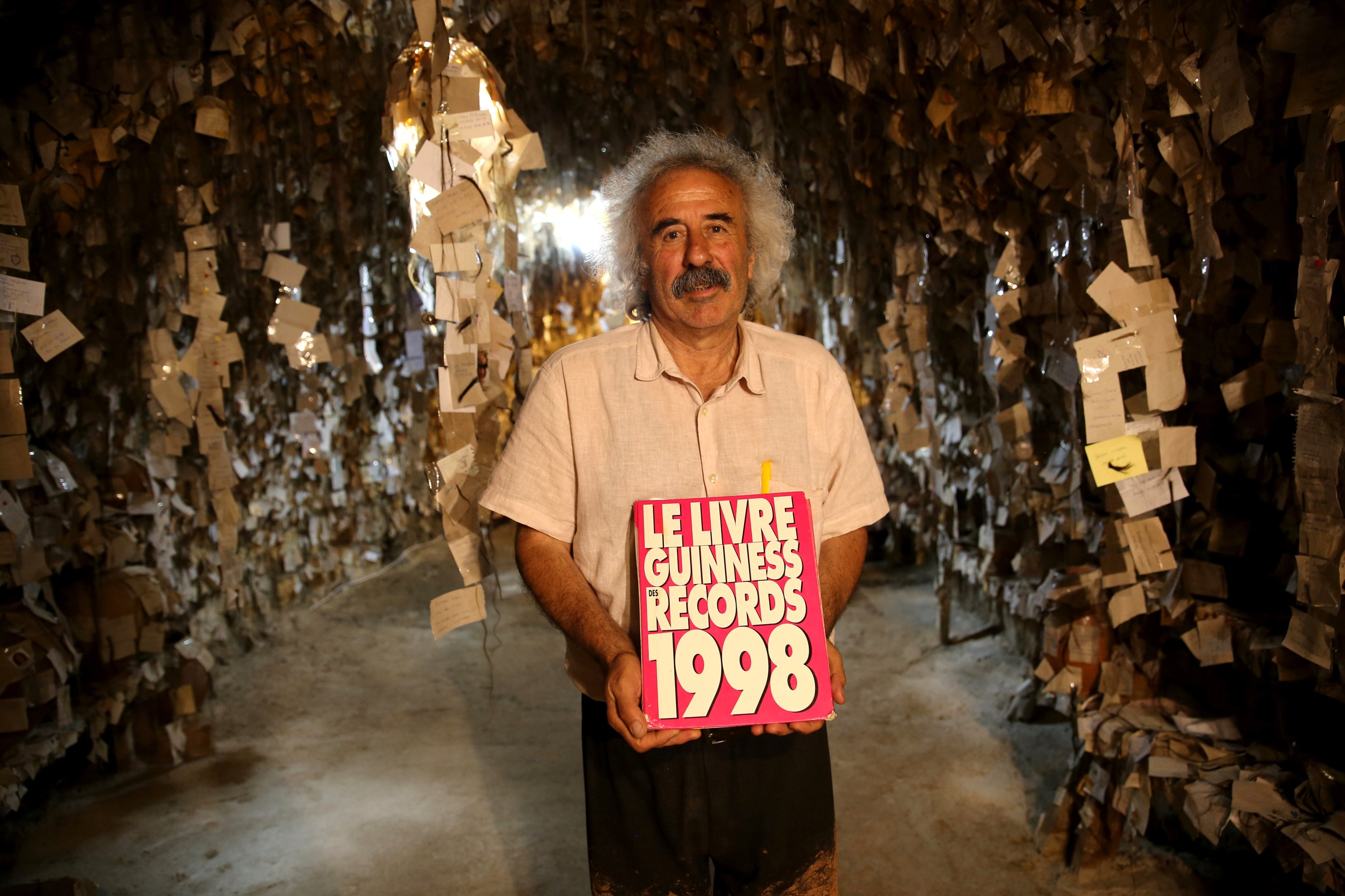 Galip Körükçü holds the 1998 'Guinness Book of World Records,' in which the Hair Museum was included. (AA Photo)
