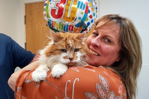 Rubble's owner Michele Heritage poses with her cat in his 30th birthday, June 4, 2020. (DHA Photo)
