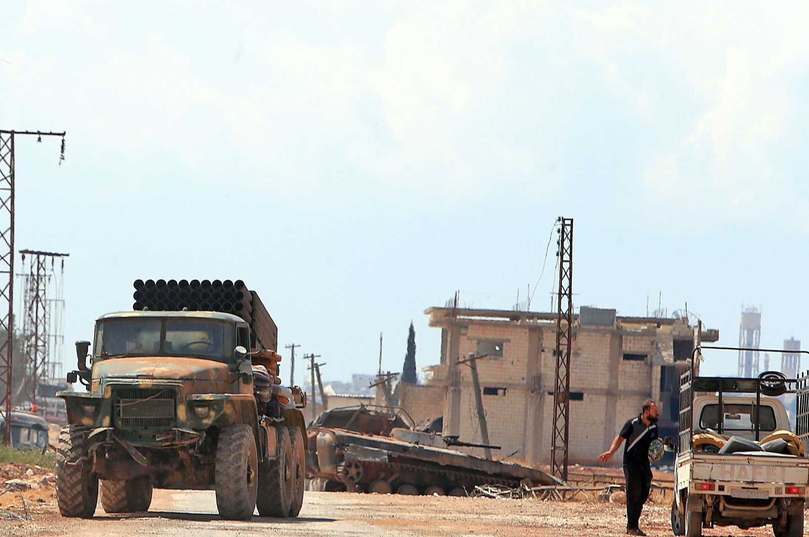Syrian regime forces gather near the town of Khan Shaykhun in the southern countryside of Idlib province, Syria, Aug. 18, 2019. (AFP Photo)