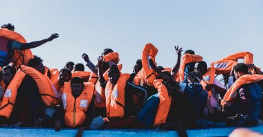Migrants on a boat wear life jackets after being rescued in the Mediterranean Sea, June 30, 2020. (AP Photo)