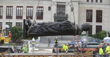 Workers remove the Christhopher Columbus statue on the Broad Street side of Columbus City Hall, Columbus, Ohio, July 1, 2020. (AP Photo)