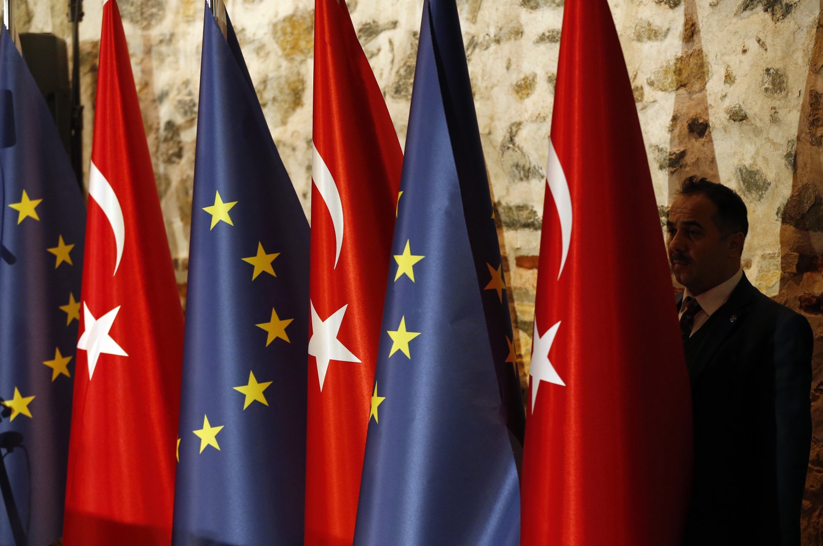 An official adjusts Turkey's and the European Union flags prior to the opening session of a high-level meeting between EU and Turkey, Istanbul, Feb. 28, 2019. (AP Photo)