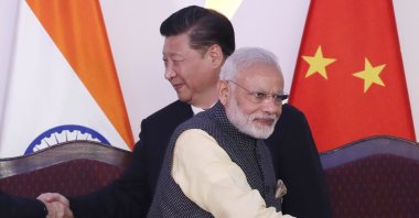 Indian Prime Minister Narendra Modi, front, and Chinese President Xi Jinping shake hands with leaders at the BRICS summit, Goa, India, Oct. 16, 2016. (AP Photo)