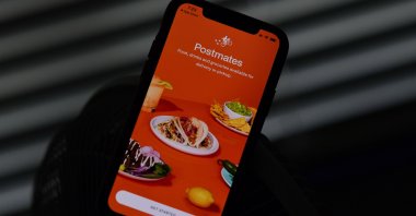 This illustration photo shows the delivery app Postmates on a smartphone screen in Los Angeles, California, U.S., June 30, 2020. (AFP Photo)
