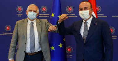 Foreign Minister Mevlüt Çavuşoğlu and Josep Borrell Fontelles, High Representative of the European Union for Foreign Affairs and Security Policy, both wearing protective face masks, pose before their meeting in Ankara, Turkey, July 6, 2020. (Turkish Foreign Ministry/Handout via Reuters)
