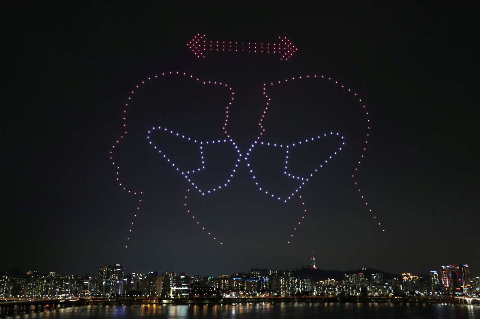 Drones fly over the Han river showing messages to support the country as a measure to avoid the spread of the coronavirus continues in Seoul, South Korea, July 4, 2020. (Yonhap via Reuters)