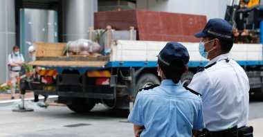 Police officers stand guard outside Metropark Hotel Causeway Bay Hong Kong believed to be used as the temporary national security agency in the city, Hong Kong, July 7, 2020. (REUTERS Photo)
