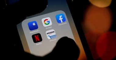 The logos of mobile apps, Google, Amazon, Facebook, Apple and Netflix, are displayed on a screen, Dec. 3, 2019. (Reuters Photo)