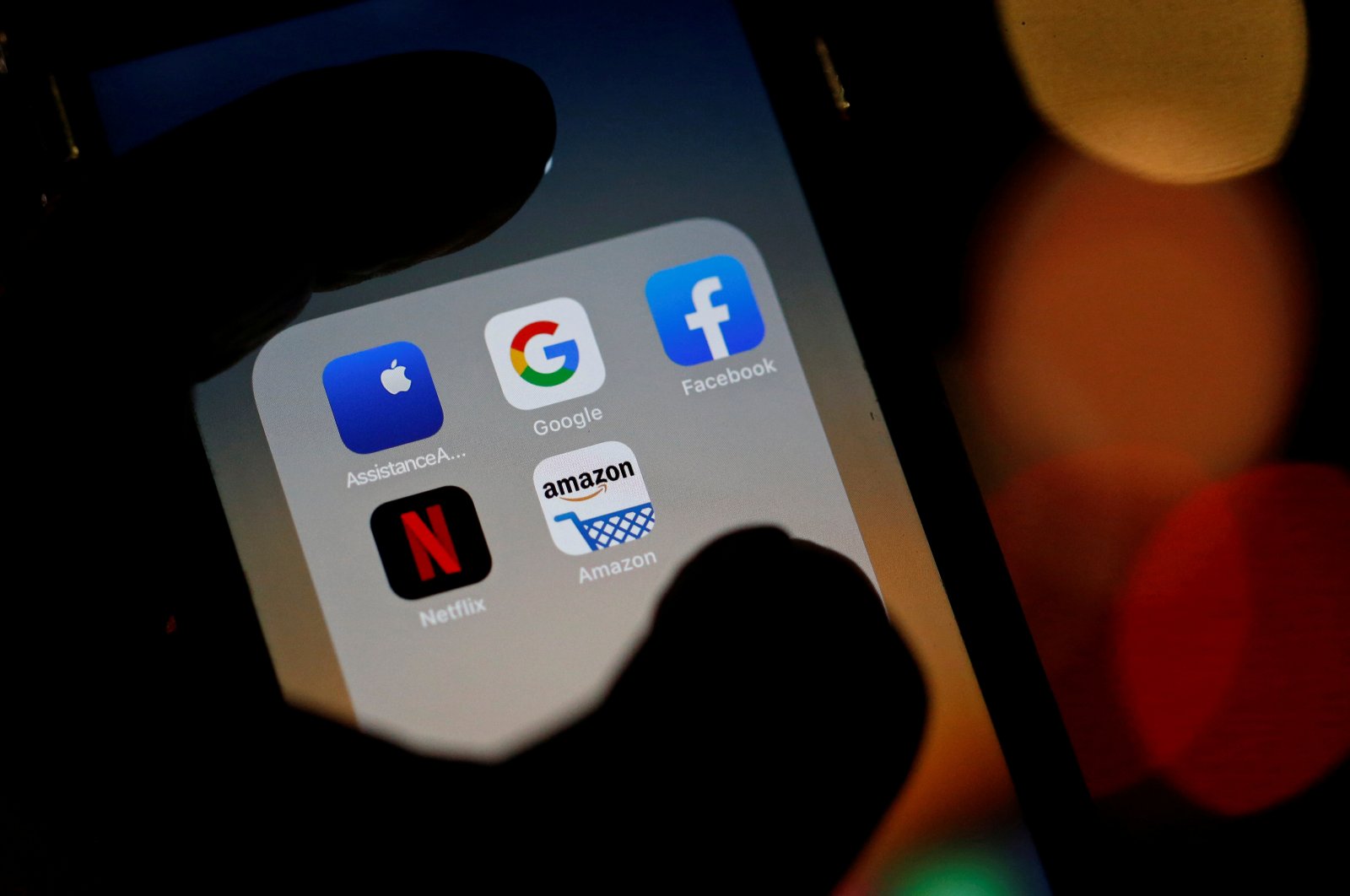 The logos of mobile apps, Google, Amazon, Facebook, Apple and Netflix, are displayed on a screen, Dec. 3, 2019. (Reuters Photo)