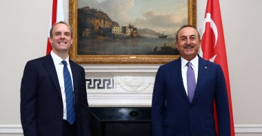 Britain's Foreign Secretary Dominic Raab (L) reacts as he poses for a photograph with Turkey's Foreign Minister Mevlüt Çavuşoğlu, at Carlton Gardens in London, on July 8, 2020. (AFP Photo)