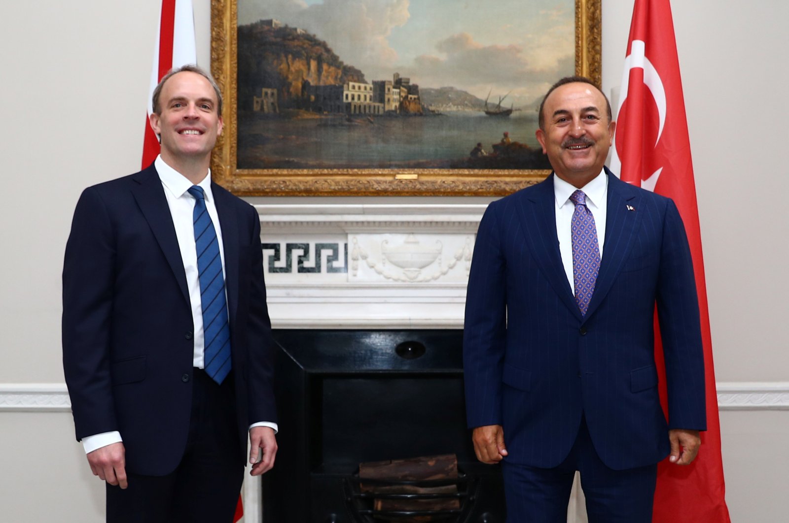 Britain's Foreign Secretary Dominic Raab (L) reacts as he poses for a photograph with Turkey's Foreign Minister Mevlüt Çavuşoğlu, at Carlton Gardens in London, on July 8, 2020. (AFP Photo)