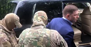 In this image distributed by the Investigative Committee of Russia (Sledkom), Sergei Furgal (R), the governor of the country's Khabarovsk region, is escorted by the Russian Federal Security Service (FSB) and Sledkom agents in Khabarovsk, Russia, July 9, 2020. (AP Photo)