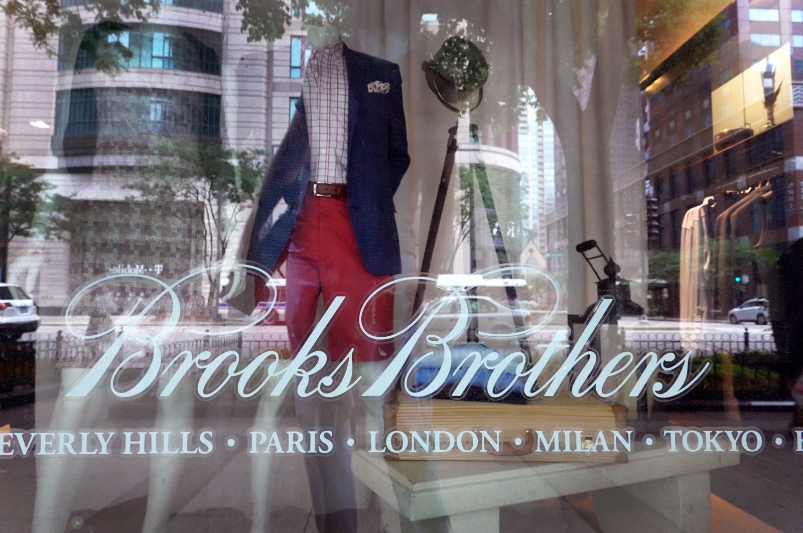 The Brooks Brothers logo is painted on the window of a store in closed along the Magnificent Mile in Chicago, Illinois, July 8, 2020. (AFP Photo)