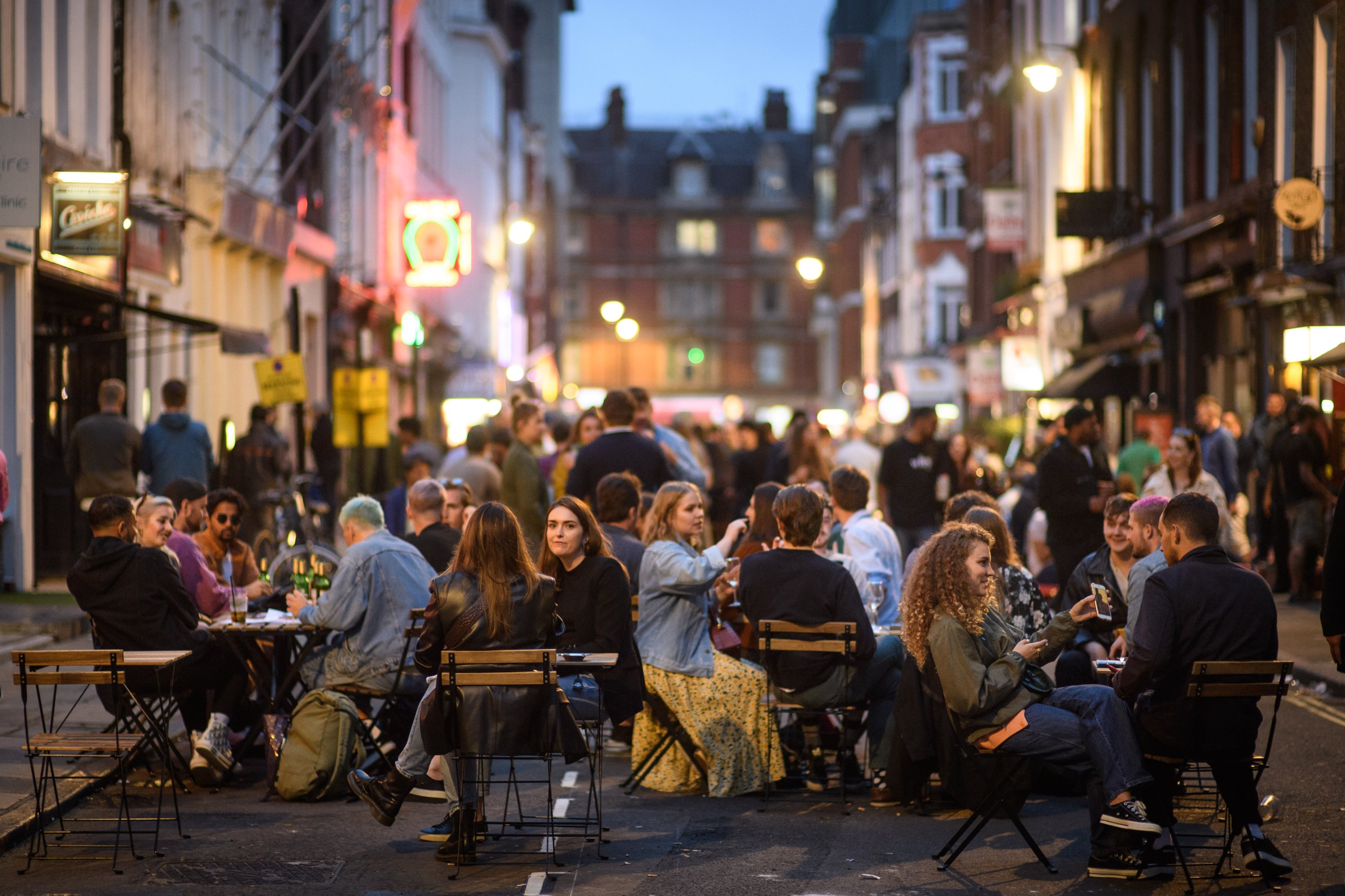 People eat and drink outdoors in Soho, London, as coronavirus lockdown restrictions are eased across England, July 5, 2020. (PA via Reuters)