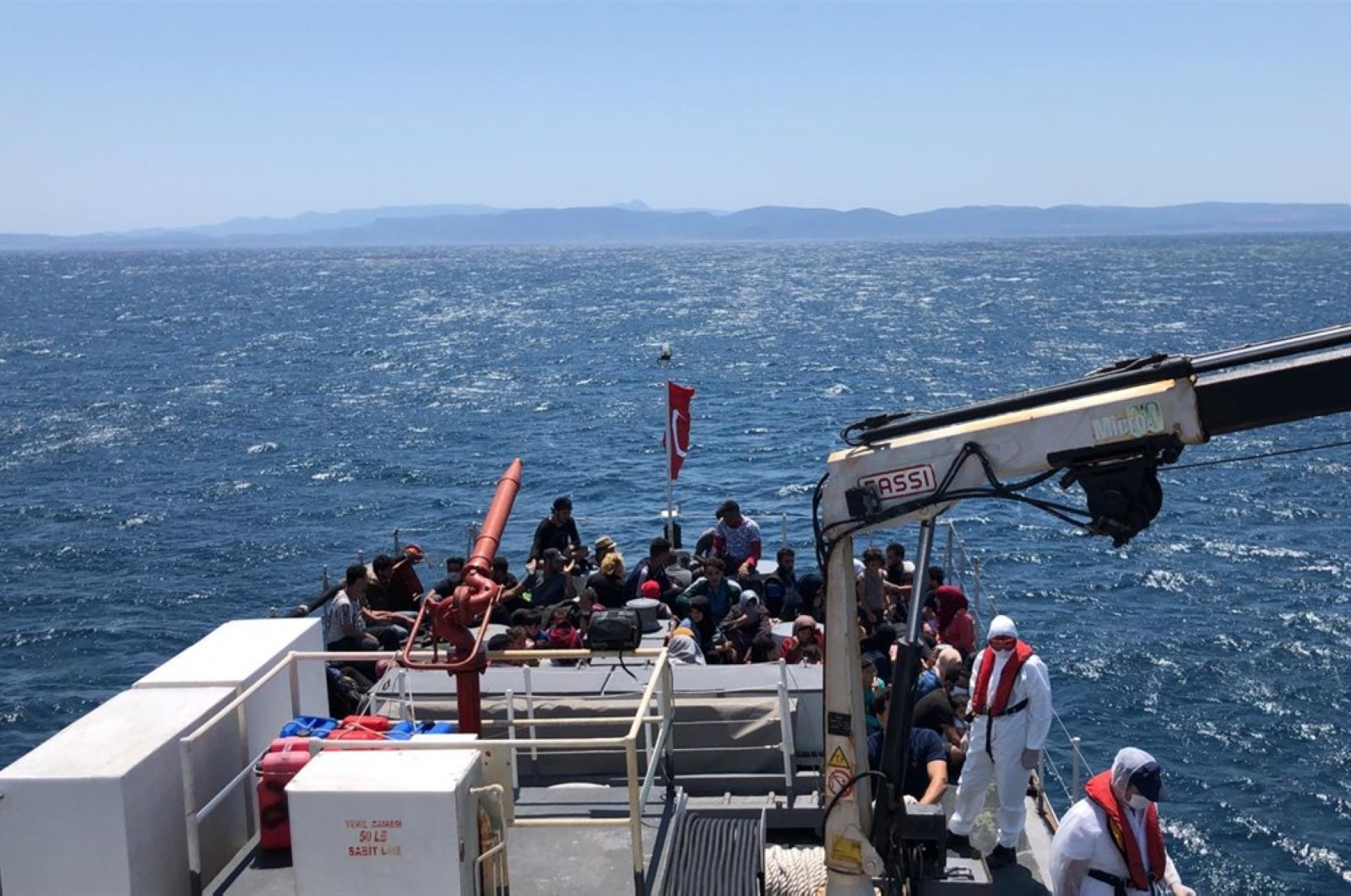The Turkish coast guard rescues 57 migrants, who set off for the Greek island of Lesbos, in the Aegean Sea off the coast of Ayvalık in the Balıkesir province, July 9, 2020. (AA Photo)