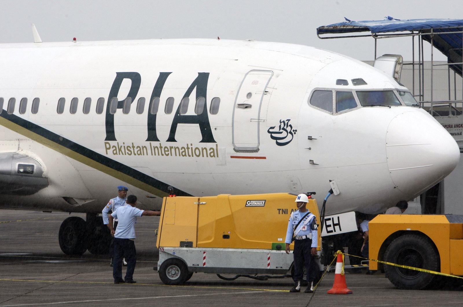 A Pakistan International Airlines passenger jet is parked on the tarmac at a military base in Makassar, Indonesia, March 7, 2011. (AP Photo)