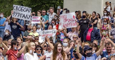 People hold posters reading "Freedom for Sergei Furgal and Hands off from Sergei Furgal!" during an unsanctioned protest in support of Sergei Furgal, the governor of the Khabarovsk region, who was interrogated and ordered to be held in jail for two months, in Khabarovsk, Russia, July 11, 2020. (AP Photo)