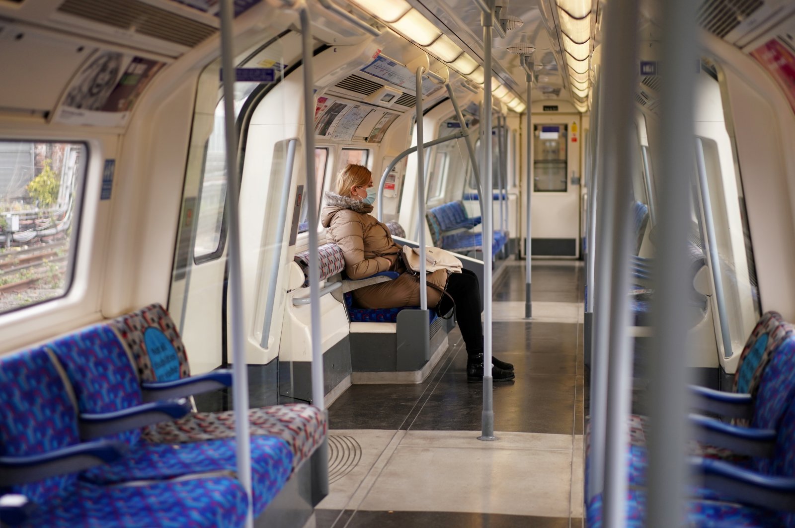 A commuter is seen on a London Underground train, following the outbreak of the coronavirus disease, London, Britain, May 13, 2020. (Reuters Photo)