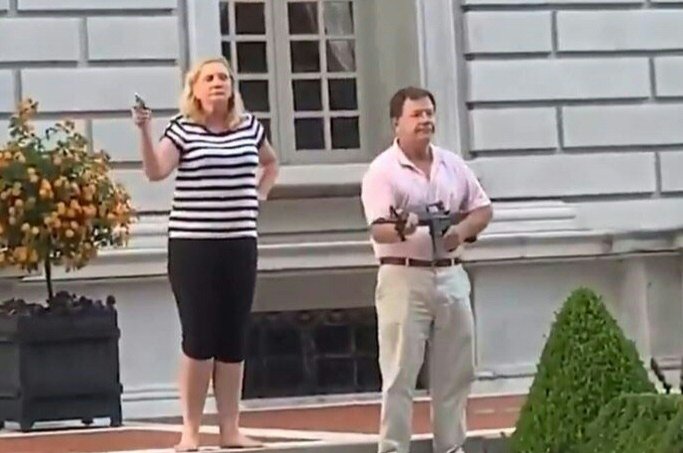 This screen grab taken from a video shows Mark McCloskey, 63, and his 61-year-old wife, Patricia, standing outside their home and holding guns including a semi-automatic rifle at Black Lives Matter protesters marching to the home of the city's mayor on June 28, 2020 in St. Louis, Missouri. (AFP Photo/Daniel Shular via Eurovision")