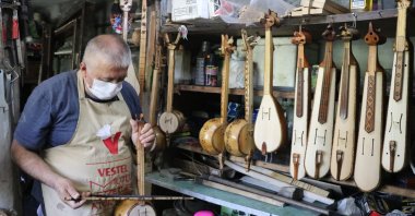 Hikmet Yılmaz plays a kabak kemane in his workshop in Zonguldak, northern Turkey, July 6, 2020. (AA PHOTO)