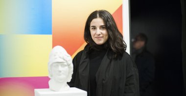 Yağmur Uyanık poses with a 3D printed sandstone sculpture, "Selfmaking: Layers of Becoming With." (Courtesy of British Council)