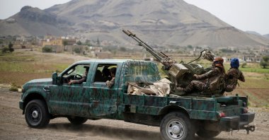 Houthi fighters man a machine gun mounted on a military truck as they parade during a gathering of Houthi loyalists on the outskirts of Sanaa, Yemen July 8, 2020. (Reuters Photo)