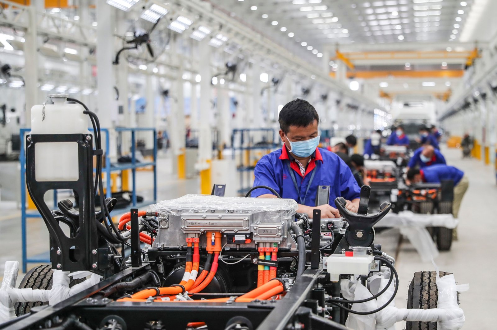 An employee working on a new energy vehicle assembly line at a BYD factory in Huaian in China's eastern Jiangsu province, July 6, 2020. (AFP Photo)