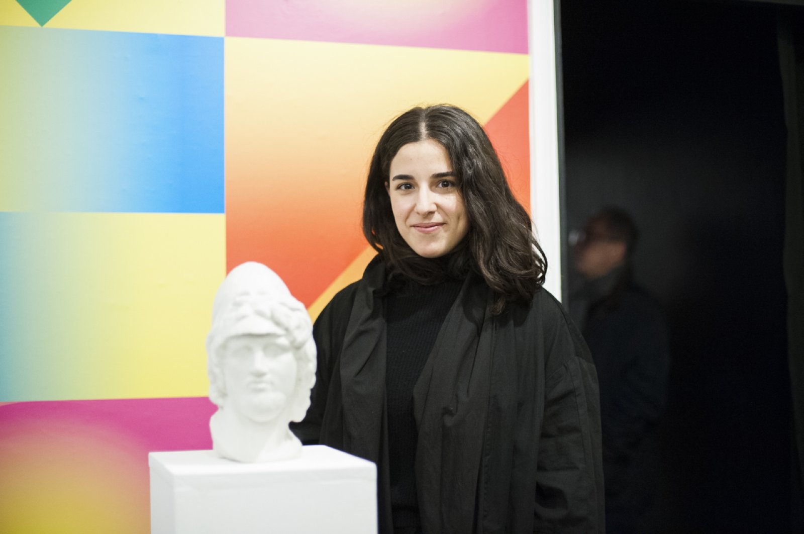 Yağmur Uyanık poses with a 3D printed sandstone sculpture, "Selfmaking: Layers of Becoming With." (Courtesy of British Council)