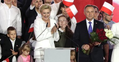 Incumbent President Andrzej Duda and his wife Agata Kornhauser-Duda smile after receiving flowers from supporters in Pultusk, Poland, July 12, 2020. (AP Photo)