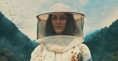 Still shot from "Kovan" showing Meryem Uzerli in her role as a beekeper woman. 