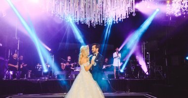 A couple dance during a wedding ceremony in Antalya province while a laser show takes place, July 13, 2020. (DHA Photo)