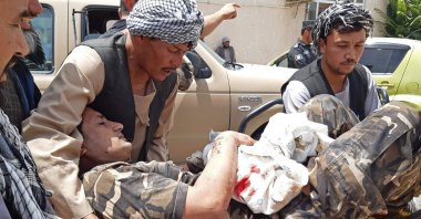 A wounded National Directorate of Security (NDS) personnel is brought on a stretcher to a hospital after a car bomb exploded in Aybak, northern Samangan province, Afghanistan, July 13, 2020. (AFP Photo)