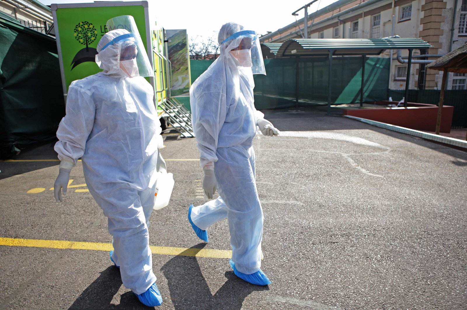 Professional health care workers wearing personal protective equipment (PPE) make their way to tents dedicated to the treatment of possible COVID-19 coronavirus patients at the Tshwane District Hospital, Pretoria, South Africa, July 10, 2020. (AFP Photo)