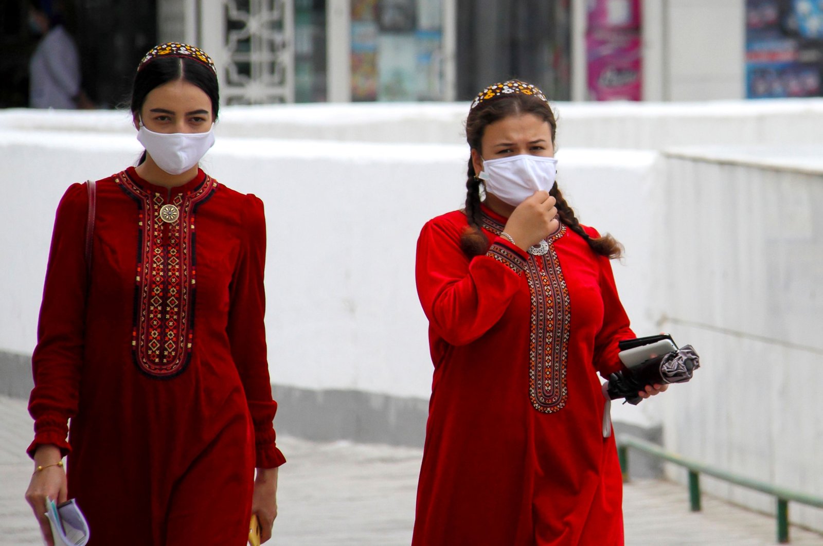 Turkmen women wearing face masks walk in Ashgabat on July 13, 2020. (Photo by STR / AFP)