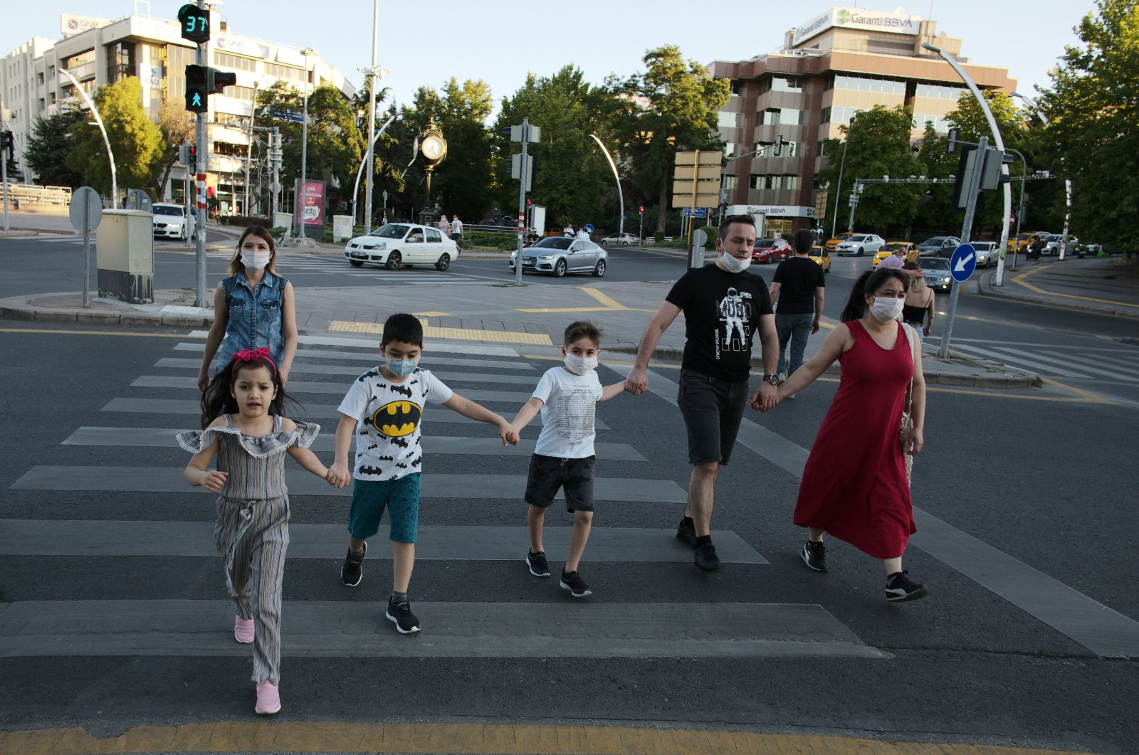People wearing face masks cross a street in Ankara, Turkey, July 11, 2020. (AP Photo)