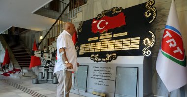 Yaşar Parlak looks at plaques bearing names of the coup attempt's victims and survivors at public broadcaster TRT's building in Istanbul, Turkey, July 10, 2020. (AA Photo)