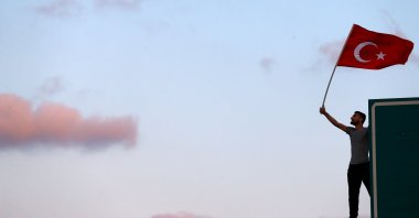 A man waves a Turkish national flag as he attends a ceremony marking the first anniversary of the attempted coup at the July 15 Martyrs Bridge in Istanbul, Turkey, July 15, 2017. (Reuters Photo)