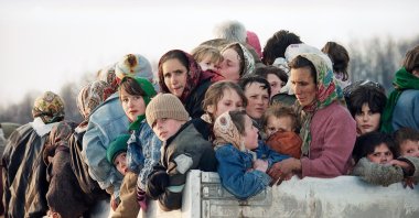 Evacuees from the besieged Muslim enclave of Srebrenica, packed on a truck en route to Bosnian city of Tuzla, pass through the Tojsici village, March 29, 1993. (AP Photo)