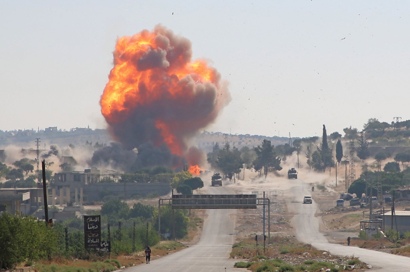 A fireball erupts from the site of an explosion reportedly targeting a joint Turkis-Russian patrol on the strategic M4 highway, near the Syrian town of Ariha in the opposition-held northwestern Idlib province, July 14, 2020. (AFP)