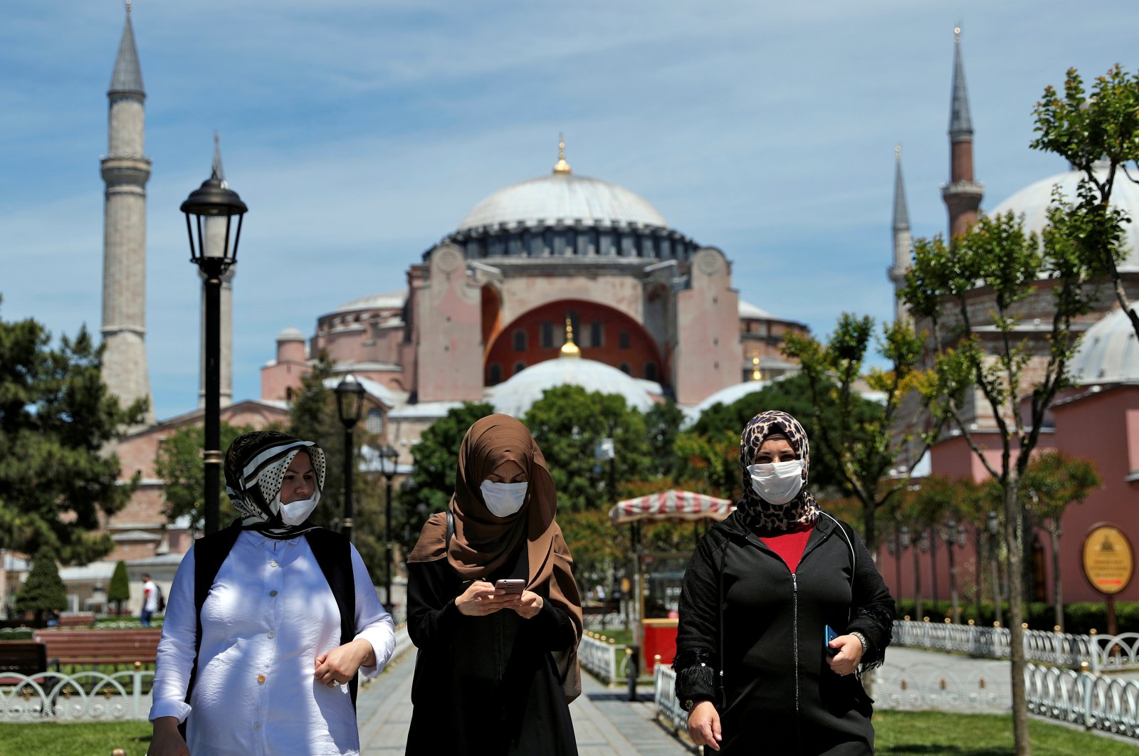 Women wearing face masks walk in front of the Hagia Sophia Mosque at the popular tourist spot Sultanahmet Square, Istanbul, Turkey, June 5, 2020. (Reuters Photo)