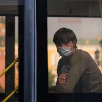 A passenger wearing a protective face mask as a preventive measure against COVID-19 looks through a bus window in Moscow, Russia, June 19, 2020. (REUTERS Photo)