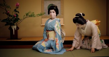 Mayu adjusts Koiku's kimono as Koiku wears a protective face mask to pose for a photograph at a luxury Japanese restaurant, Tokyo, Japan, June 23, 2020. (Reuters Photo)