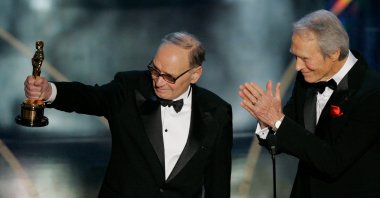 Italian composer Ennio Morricone (L), accepts an honorary Oscar for his contributions to the art of film music as director Clint Eastwood looks on during the 79th Academy Awards telecast in Los Angeles on Feb. 25, 2007. (AP Photo)
