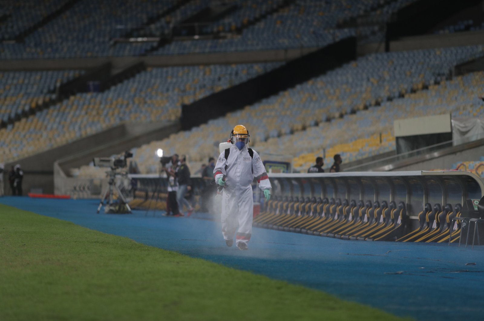 A man in a protective suit sprays disinfectant as a means of preventing the spread of the coronavirus during the Carioca Championship second leg final match between Flamengo and Fluminenes at Maracana stadium in Rio de Janeiro, Brazil, July 15, 2020. (EPA Photo)