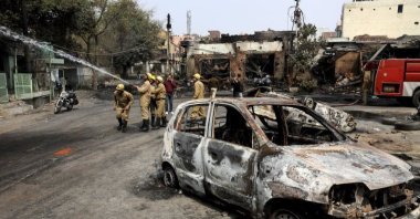 Firefighters douse a fire at Gokulpuri tire market, New Delhi, India, Feb. 26, 2020. (AP Photo)