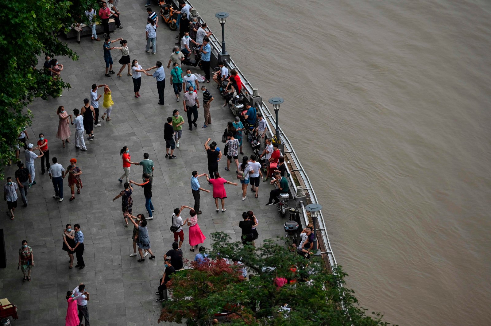 People dance next to the Yangtze in Wuhan, central Hubei province, China, July 14, 2020.  (AFP Photo)